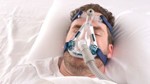 male patient in a CPAP mask to treat sleep apnea in Greenwich, CT