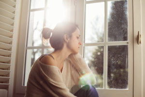 Thoughtful woman at home - copyspace